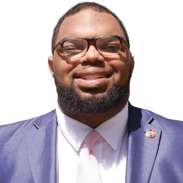 Bruce Johnson in a suit, smiling at the camera against a white background.